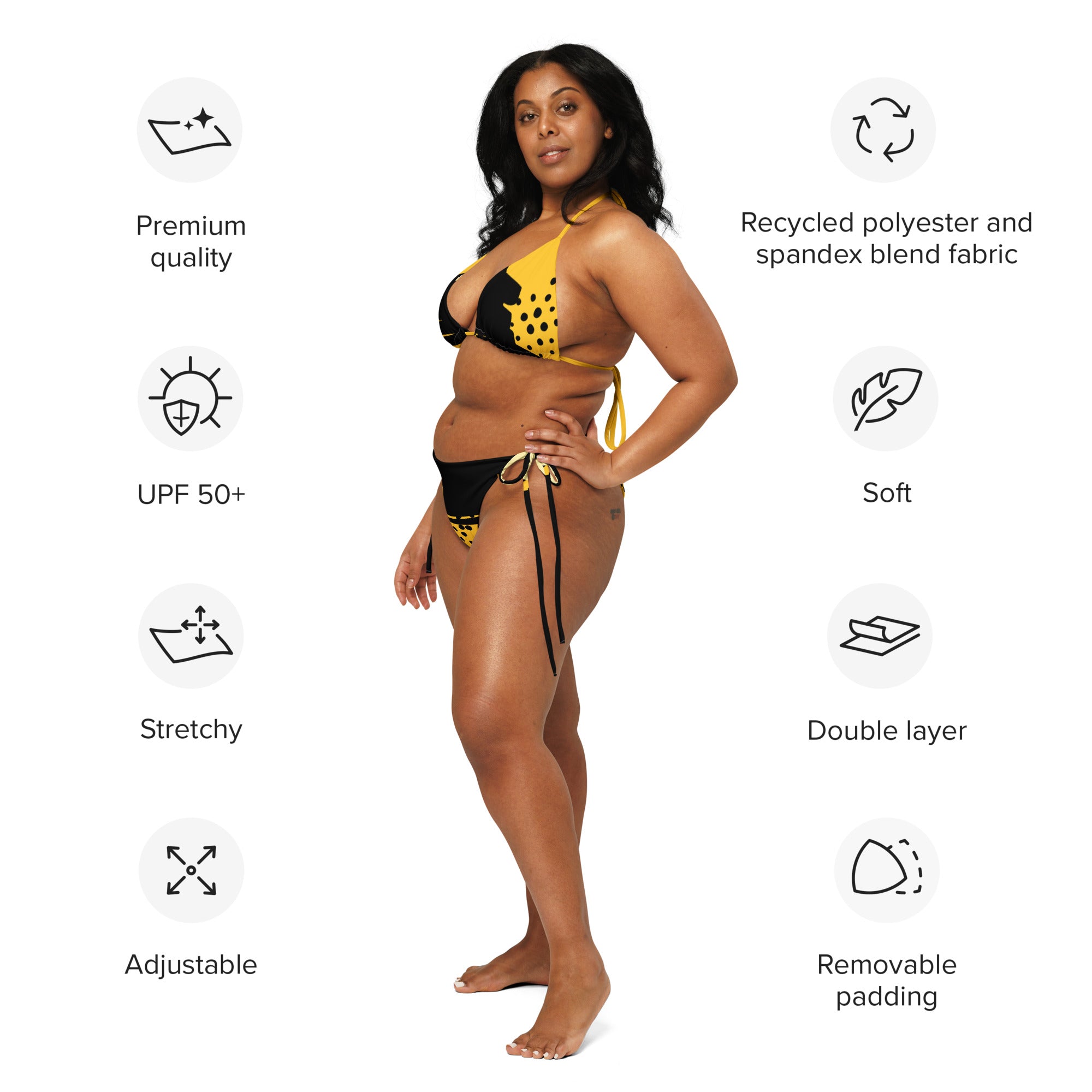 Plus size woman wearing yellow black abstract bikini standing sideways with adjustable straps