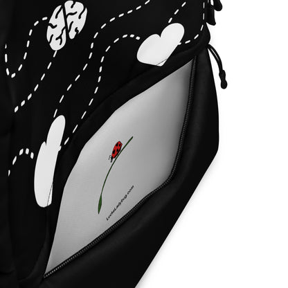 LuckeLadybug Black Backpack With White Hearts with front zip pocket open showing white interior and ladybug logo