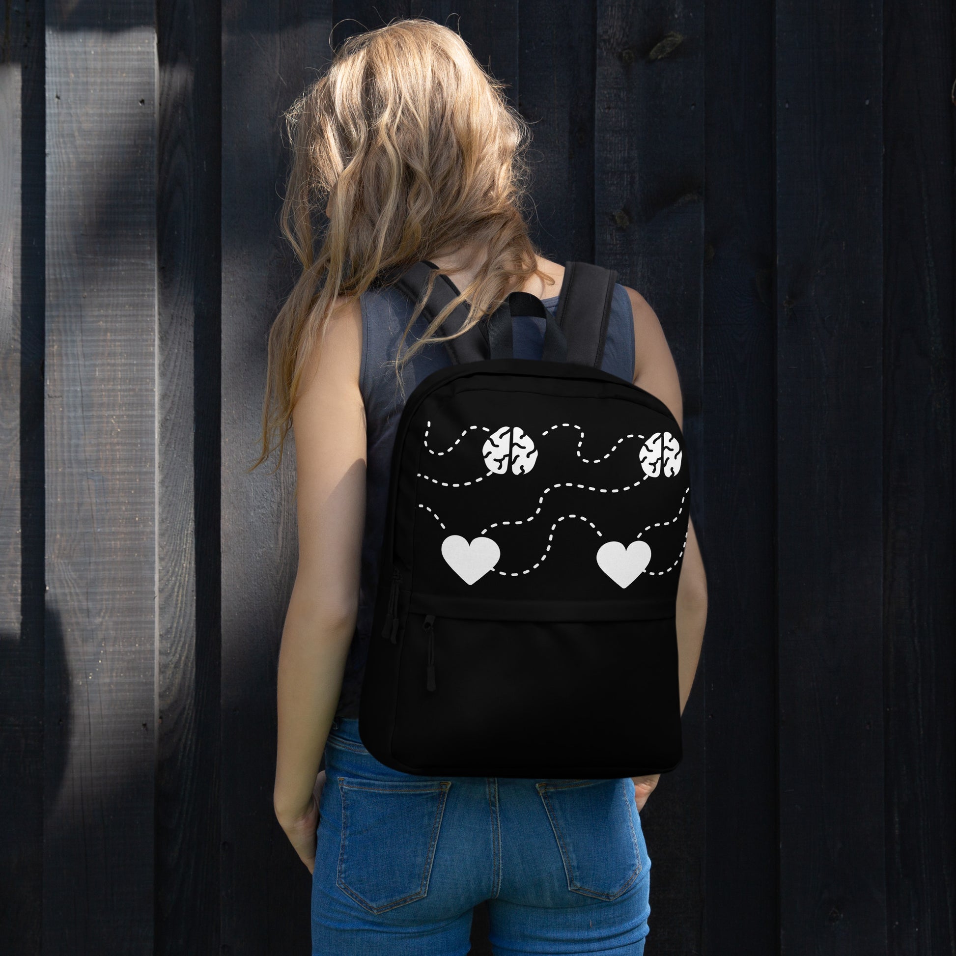 Black Backpack With White Hearts LuckeLadybug casual backpack on a woman showing white heart and dotted floral design