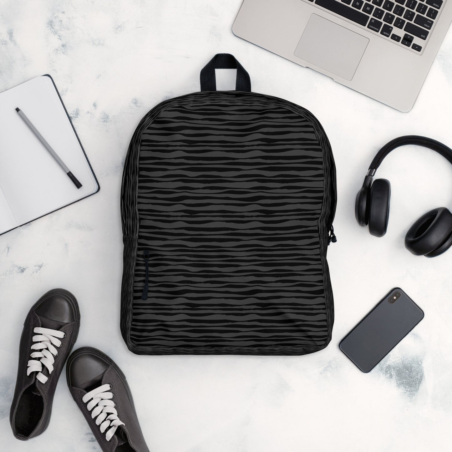 LuckeLadybug black striped backpack shown with laptop headphones phone and sneakers for daily commute