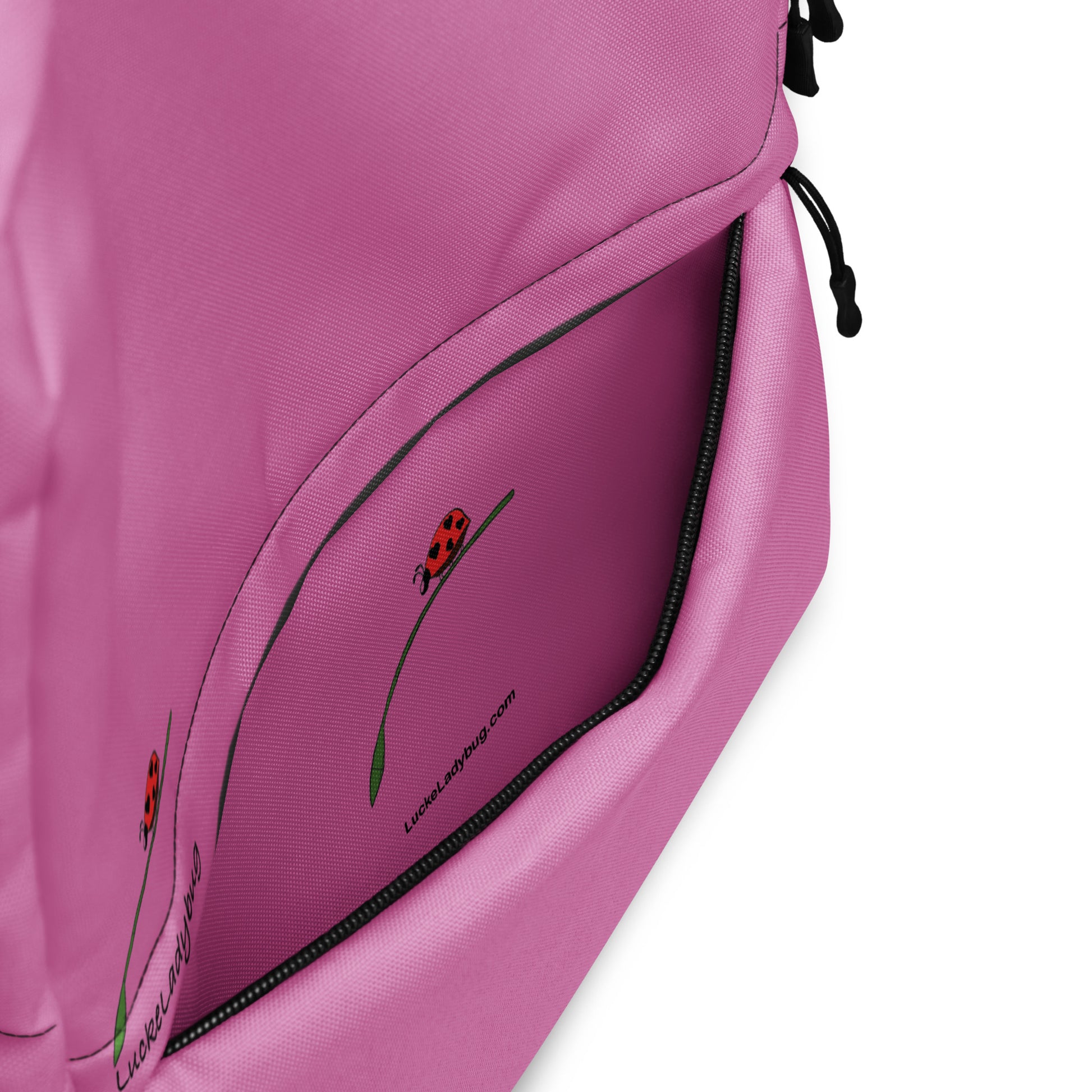 Close-up of pink backpack for teens and adults with zippered front pocket and LuckeLadybug logo