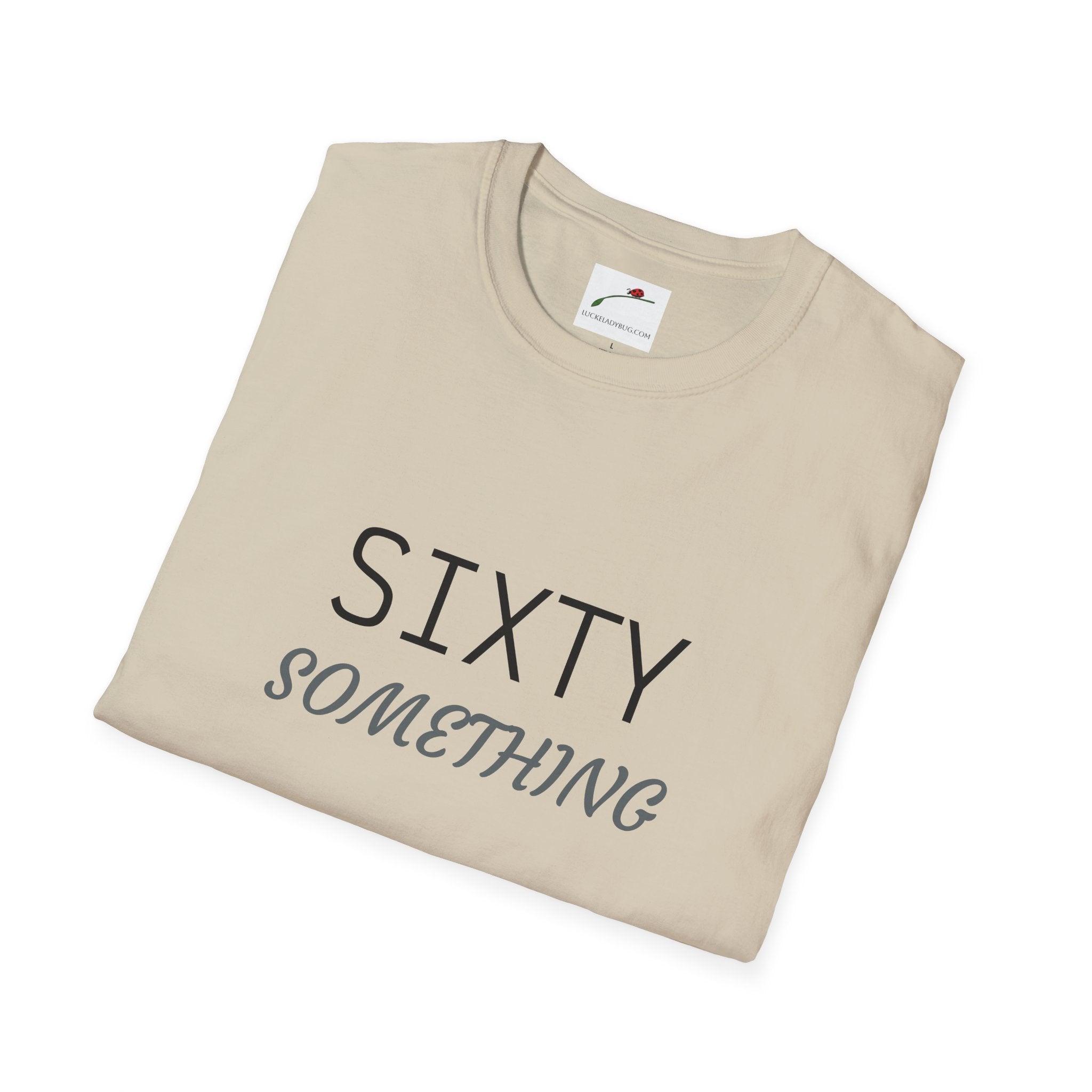 Beige LuckeLadybug sixty something birthday shirt with black and gray text design folded neatly