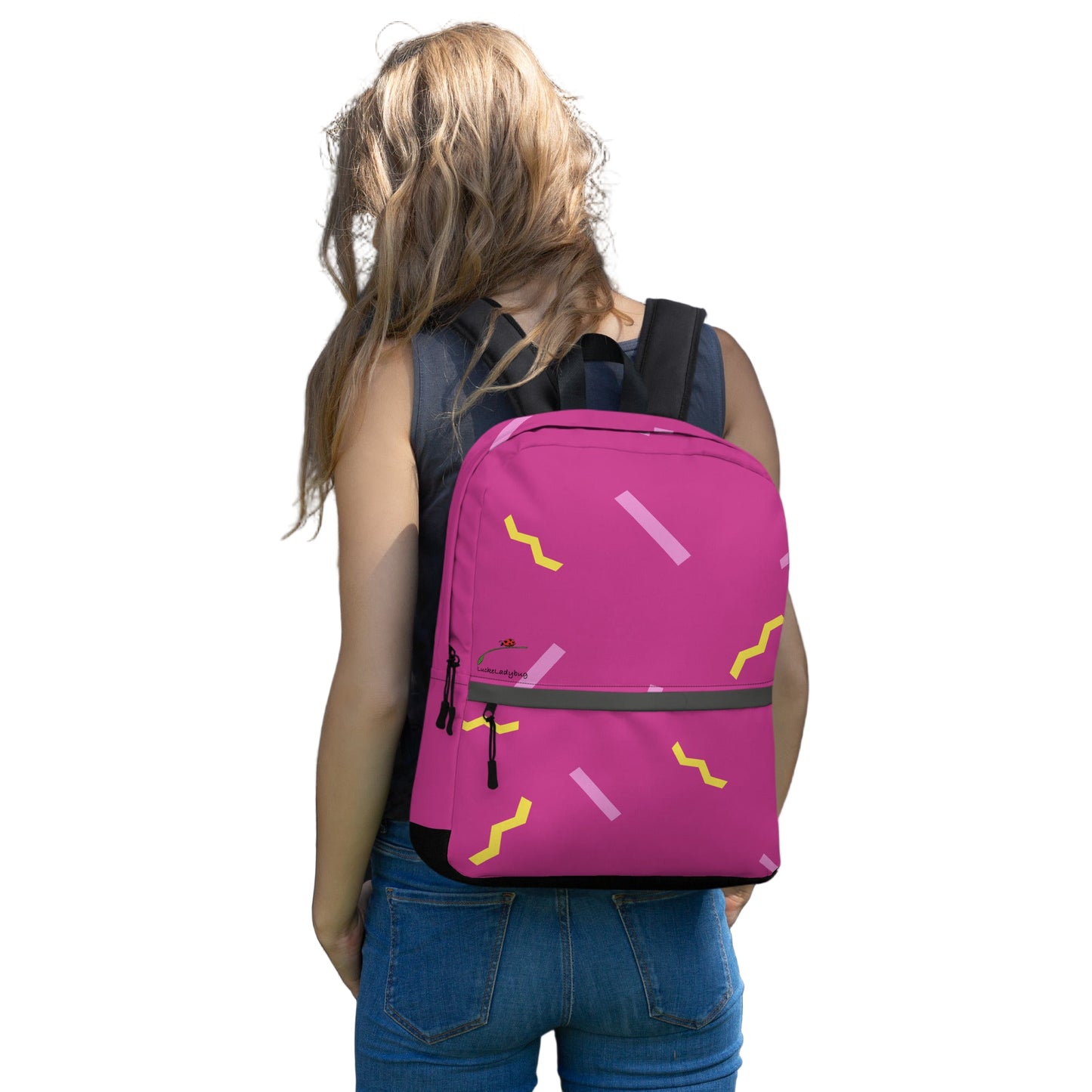 Stylish school backpack in pink with yellow and pink accents worn by a woman outdoors