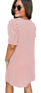 LuckeLadybug parchment knit mini dress back view on smiling model with puff sleeves and sunglasses
