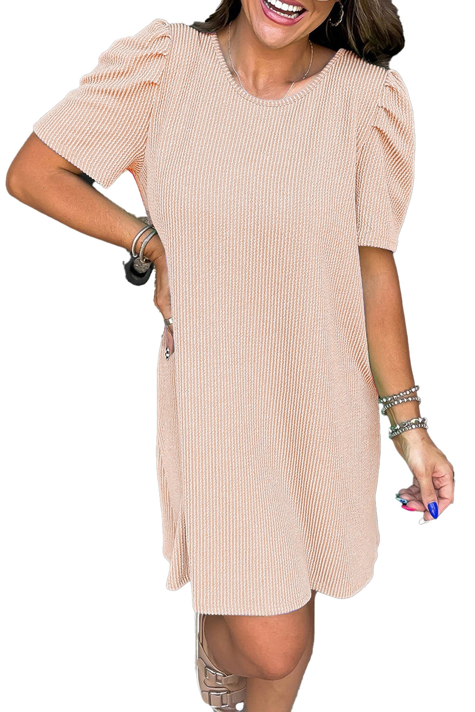 Model wearing parchment knit mini dress with ribbed texture and puff sleeves casual above knee shift silhouette