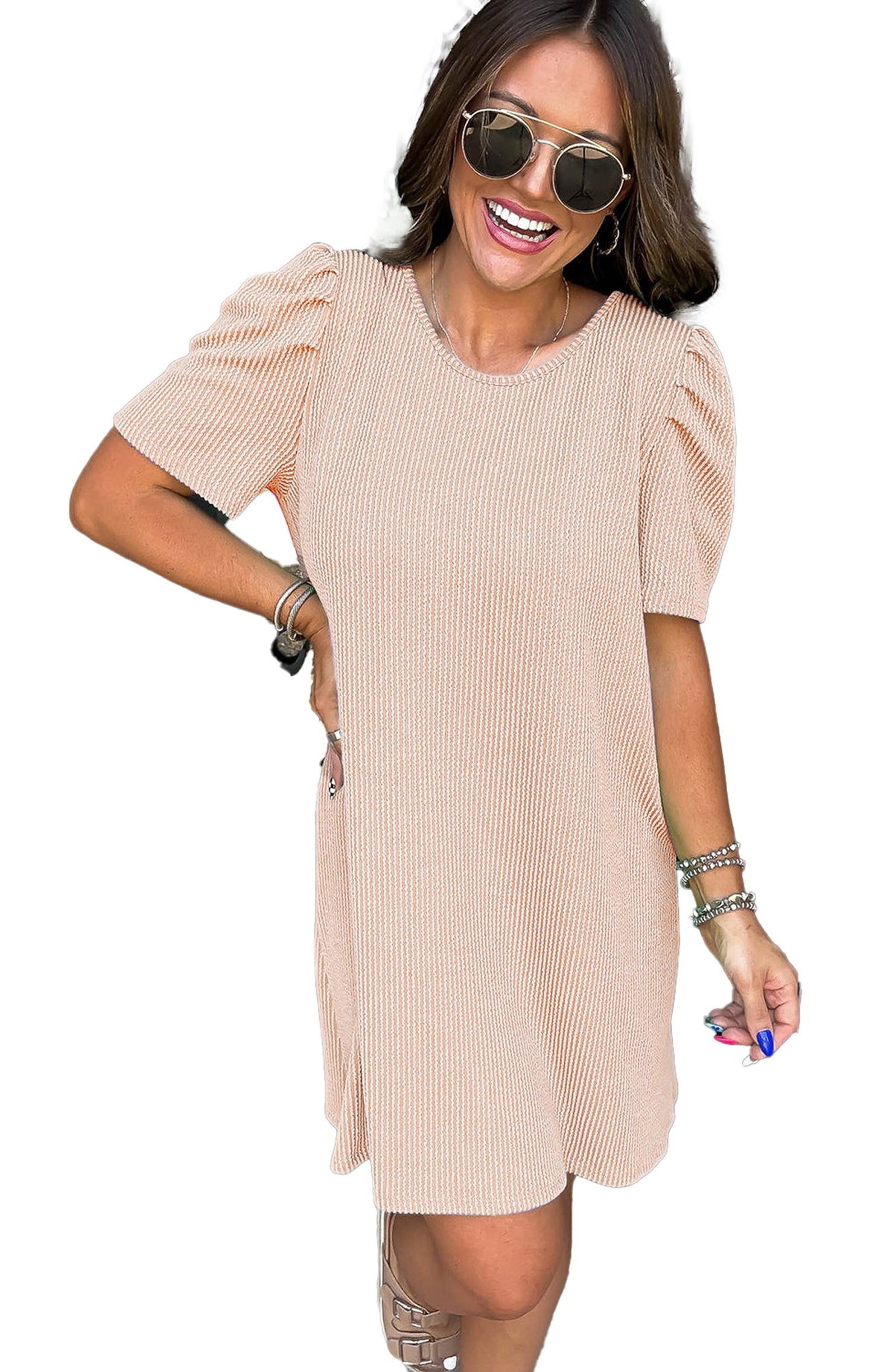 Model wearing LuckeLadybug parchment knit mini dress with puff sleeves sunglasses smiling at front door