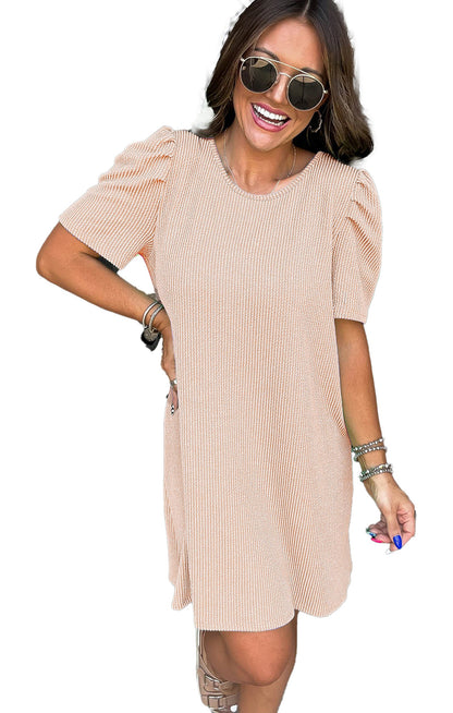 Model wearing LuckeLadybug parchment knit mini dress with puff sleeves sunglasses smiling at front door