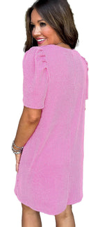 LuckeLadybug H Line parchment knit mini dress in pink textured knit with puff sleeves on smiling model