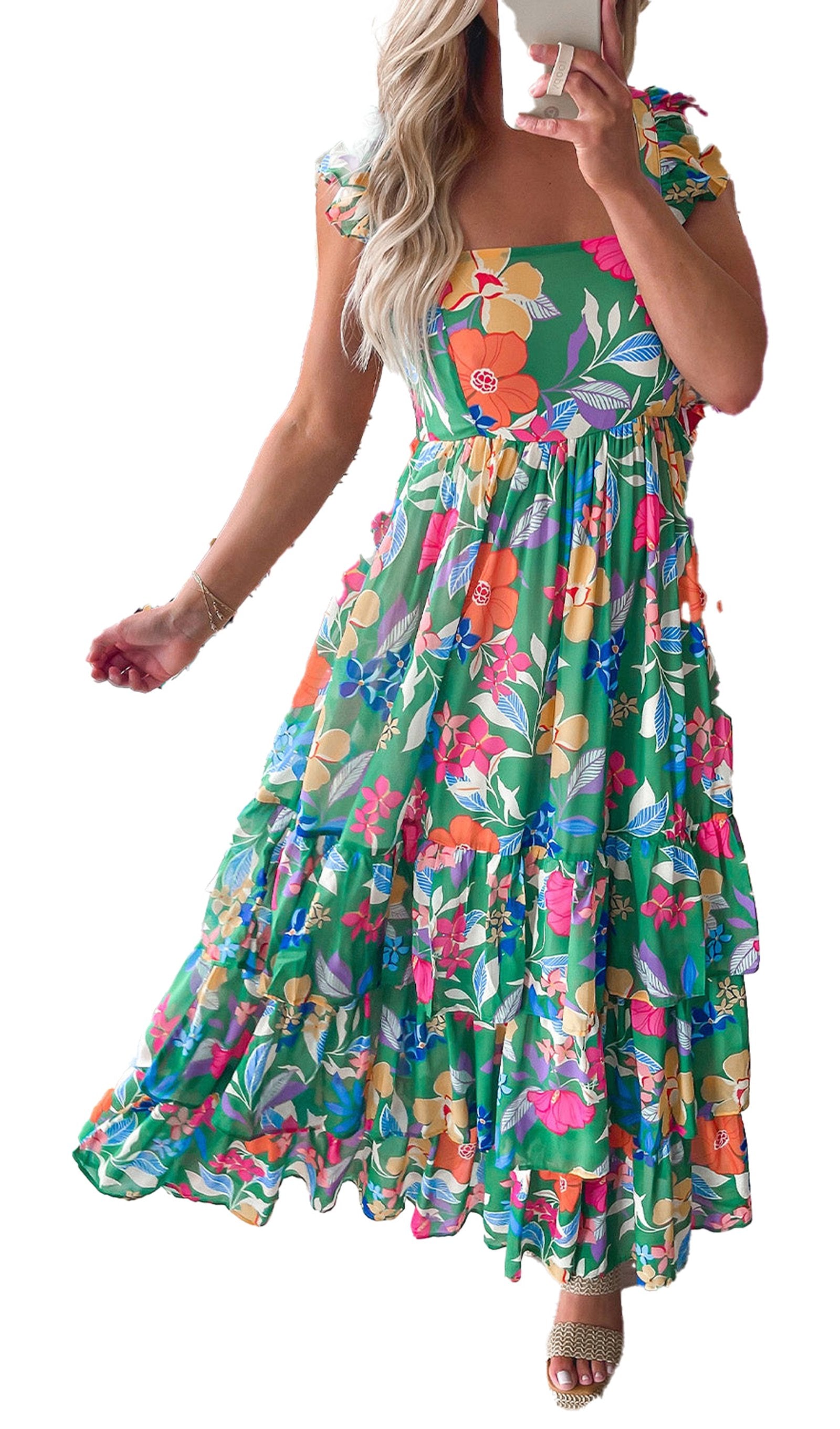 green floral maxi dress with square neckline ruffle sleeves and tiered skirt worn by model in boutique