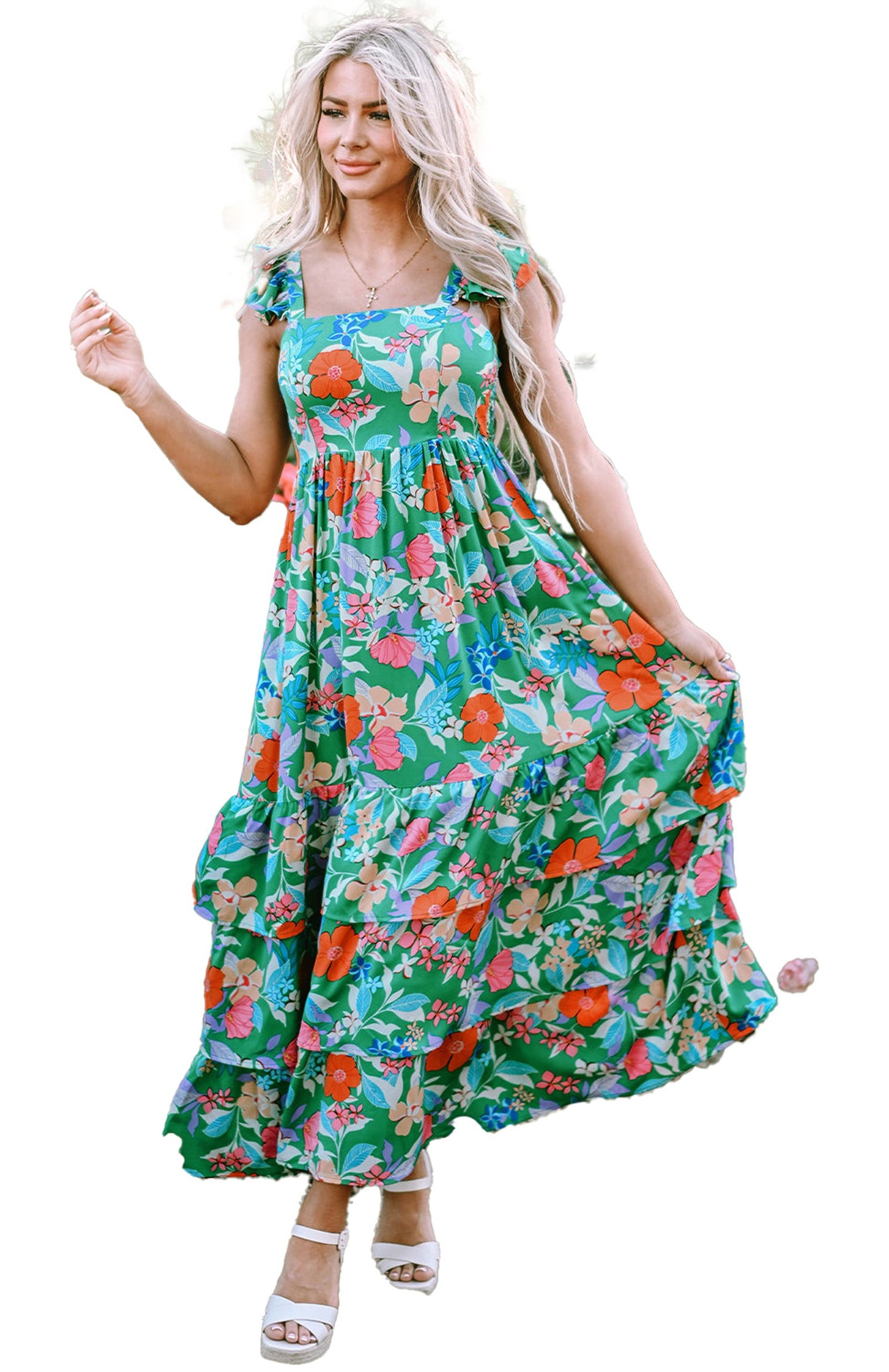 LuckeLadybug green floral maxi dress on model in garden with tiered skirt and tie straps
