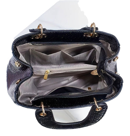 Interior view of a luxury crocodile print handbag with multiple compartments for organized storage
