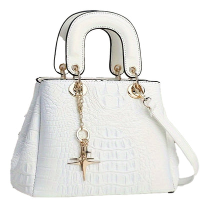 White luxury crocodile print handbag with gold accents and detachable charm for stylish outfits
