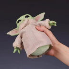 LuckyLadybug LLC Mandalorian action figure of a cute green character in a beige coat