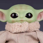 Cute Mandalorian action figure with oversized ears and soft clothing detail