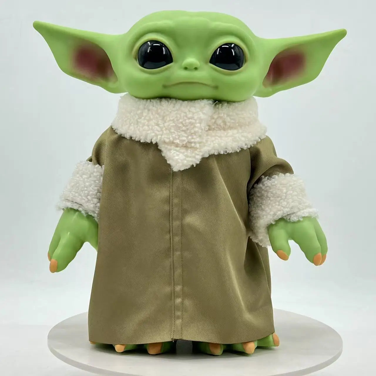 Cute Mandalorian action figure of a green character wearing a fluffy coat with big eyes