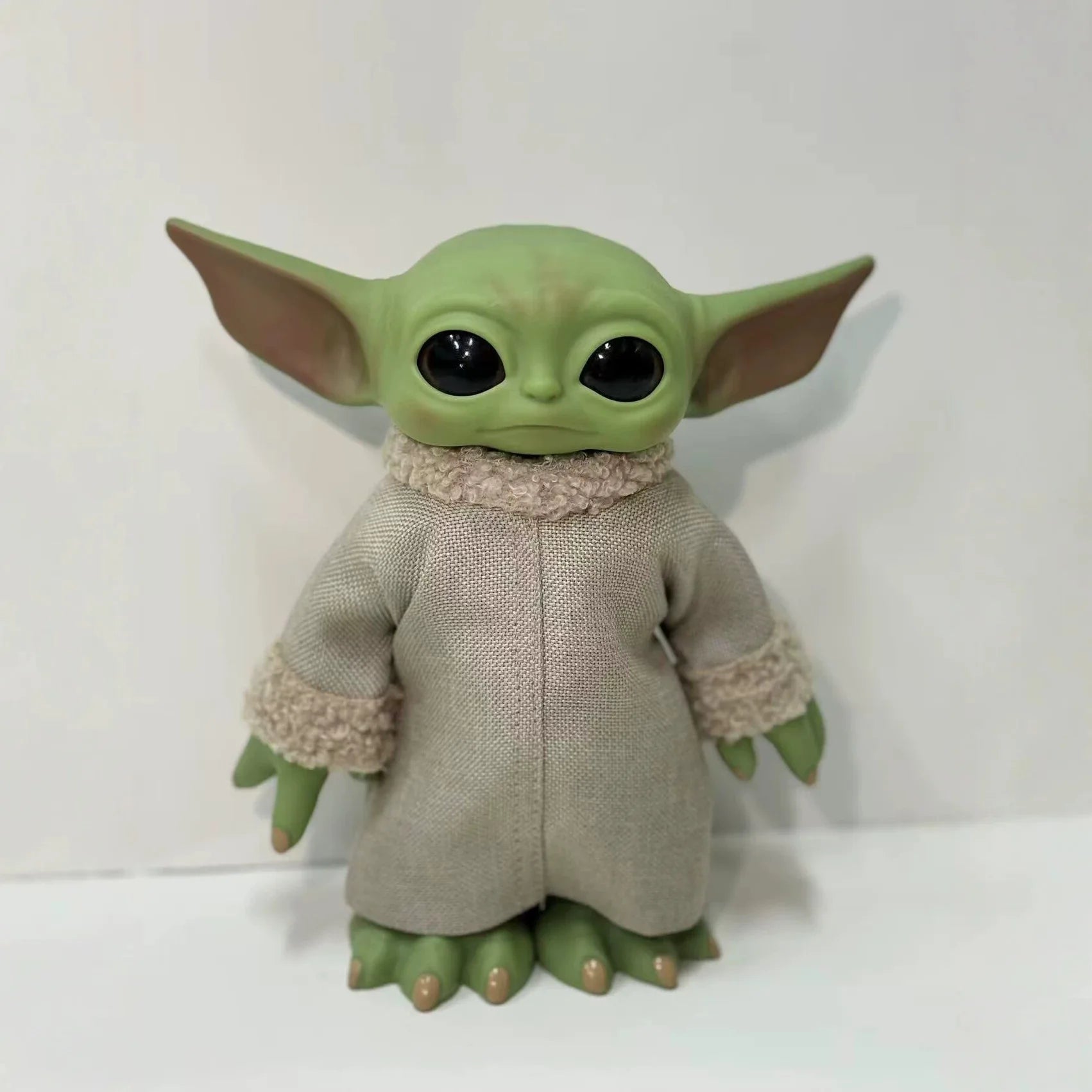 Mandalorian action figure featuring a cute character with large ears and a soft robe, perfect for collectors