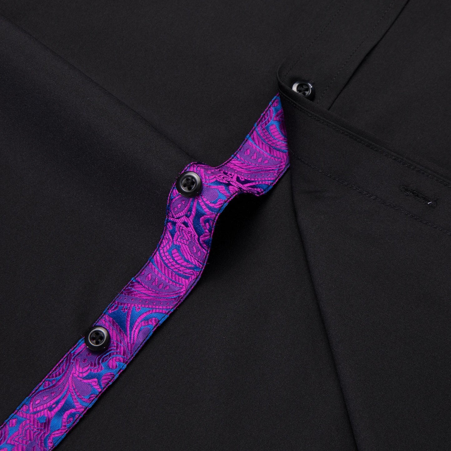 Detail of men's black shirt with purple collar featuring stylish buttons and elegant stitching