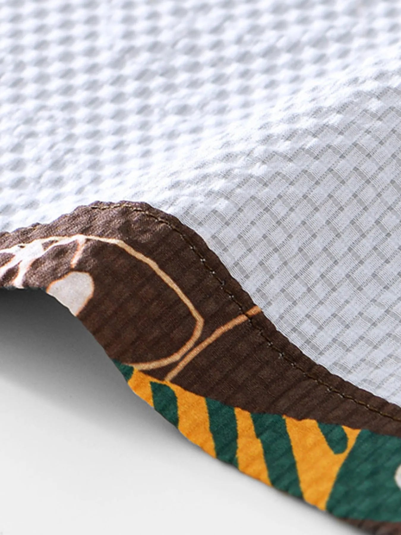Close-up of a LuckeLadybug LLC button-up featuring detailed mens t shirt graphics on the hem