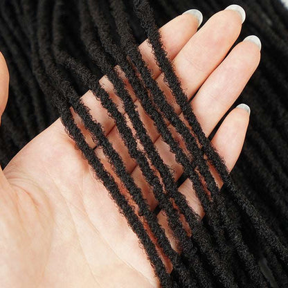 Close-up of black micro faux locs for women held in hand from LuckeLadybug LLC wig collection