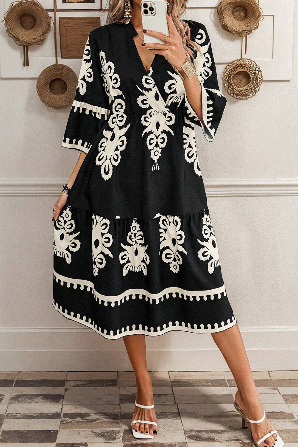 Black and white patterned midi dress from LuckeLadybug LLC with a fit and flare design and tiered skirt
