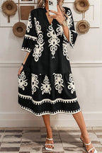 Black and white patterned midi dress from LuckeLadybug LLC with a fit and flare design and tiered skirt