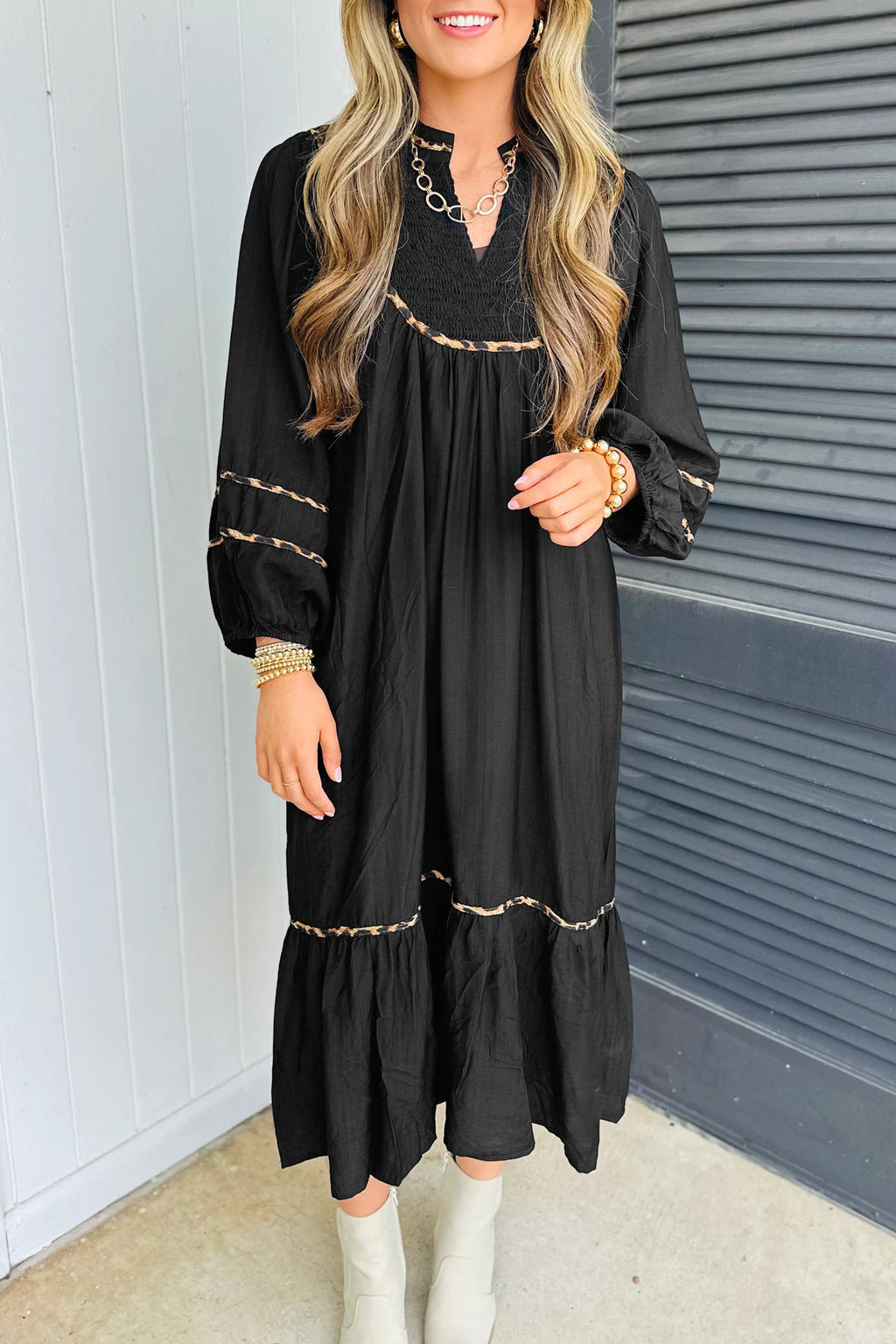 Stylish black midi dress by LuckeLadybug LLC with balloon sleeves and decorative embroidery