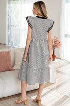 Back view of a black and white striped midi dress with ruffled sleeves and a tiered hem