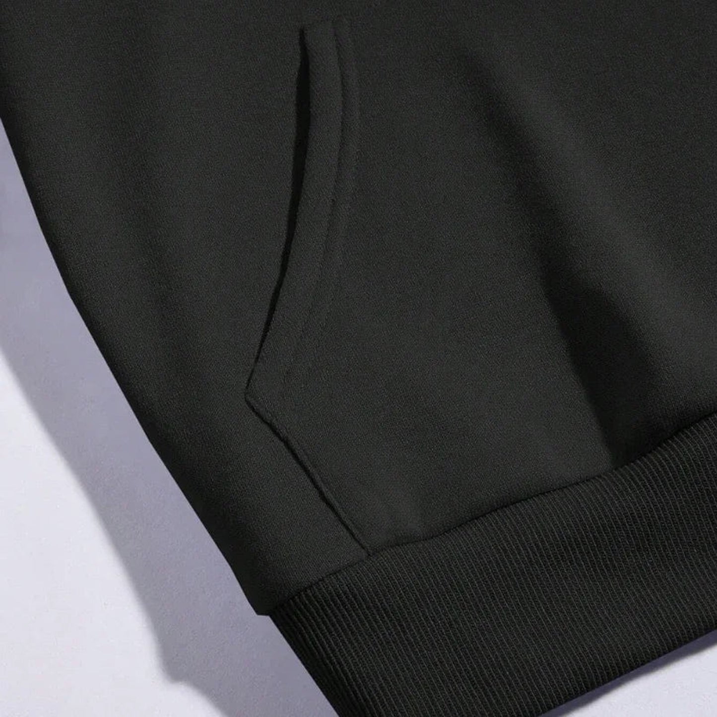 Close-up of a black moon print hoodie for women featuring a kangaroo pocket and ribbed cuffs