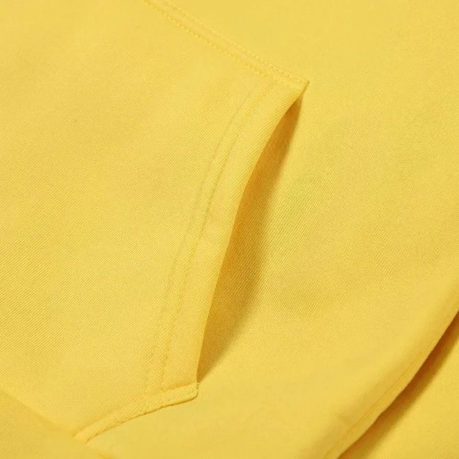 Close-up of a yellow moon print hoodie for women featuring a front pocket and soft fabric