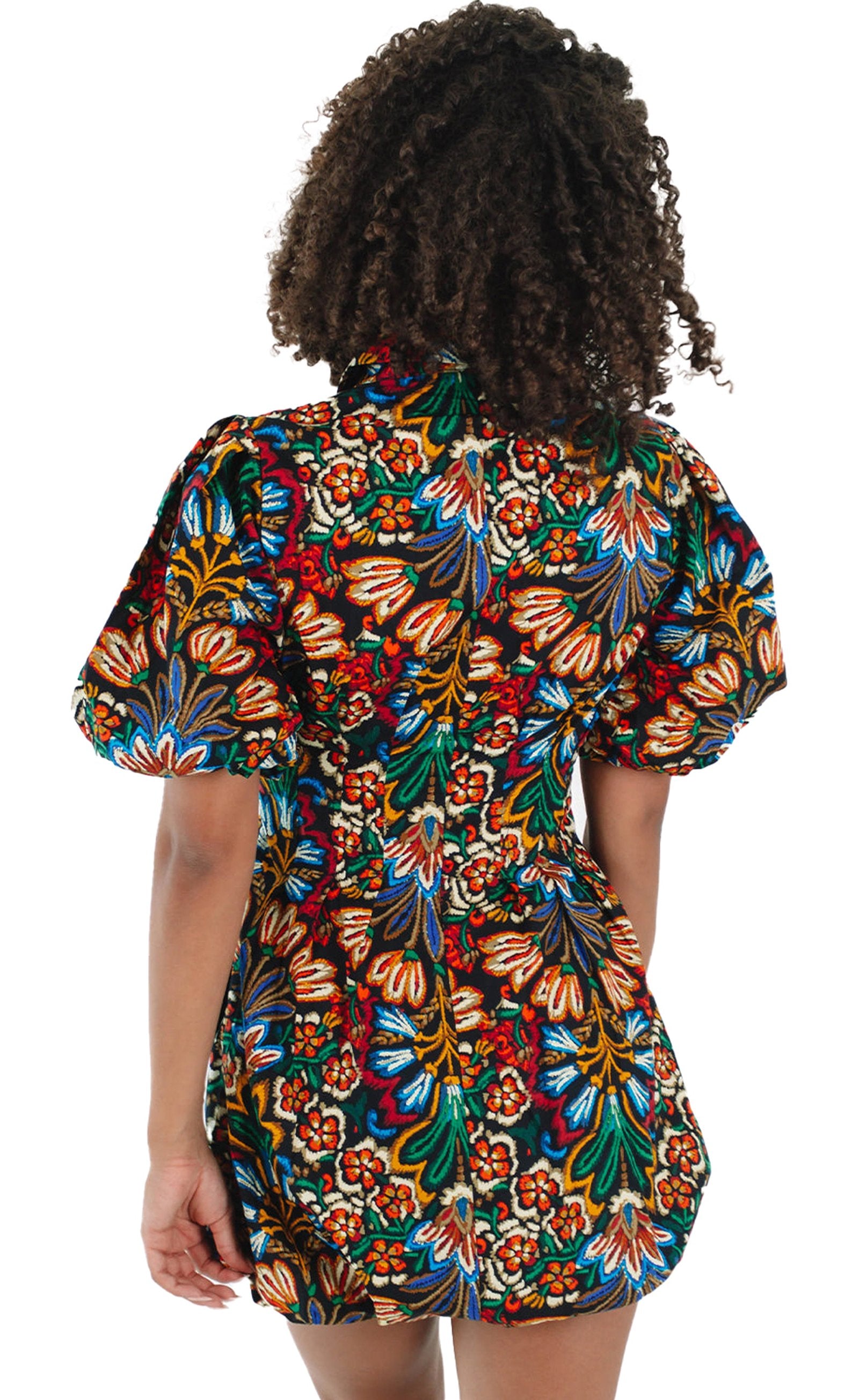 Back view of LuckeLadybug multicolor floral puff sleeve dress showcasing vibrant floral patterns and a fitted silhouette