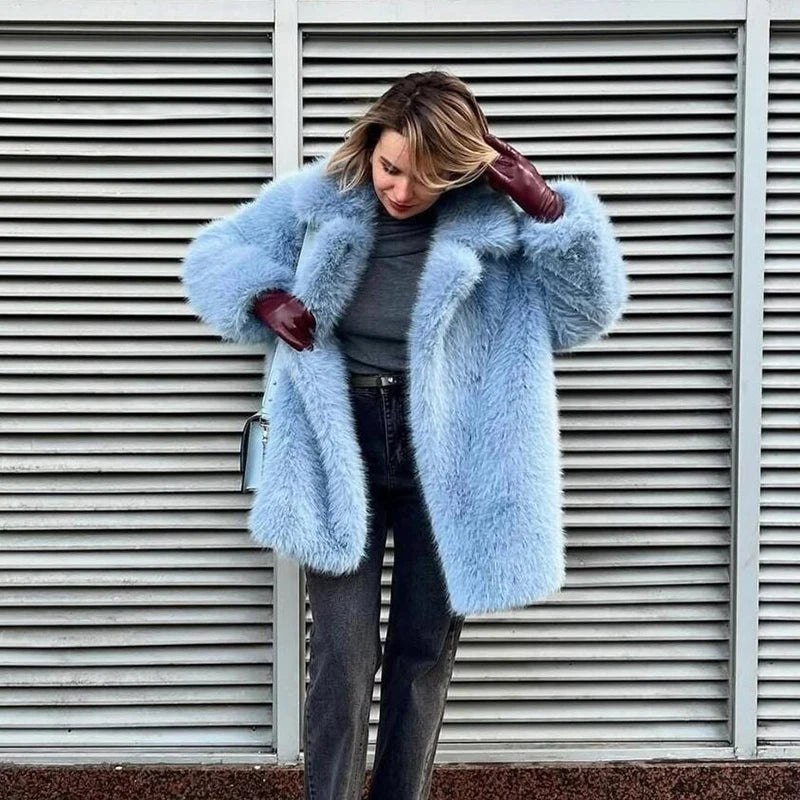 Stylish woman wearing a neo mint faux fur coat for women with gray top and leather gloves