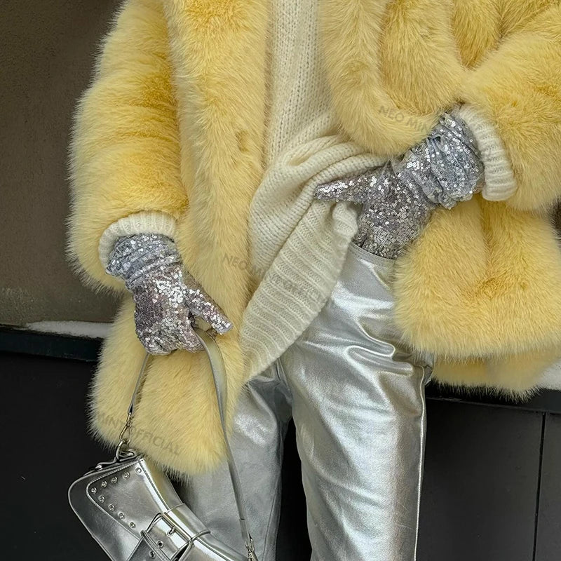 Stylish neo mint faux fur coat for women paired with a cozy sweater and shiny silver pants
