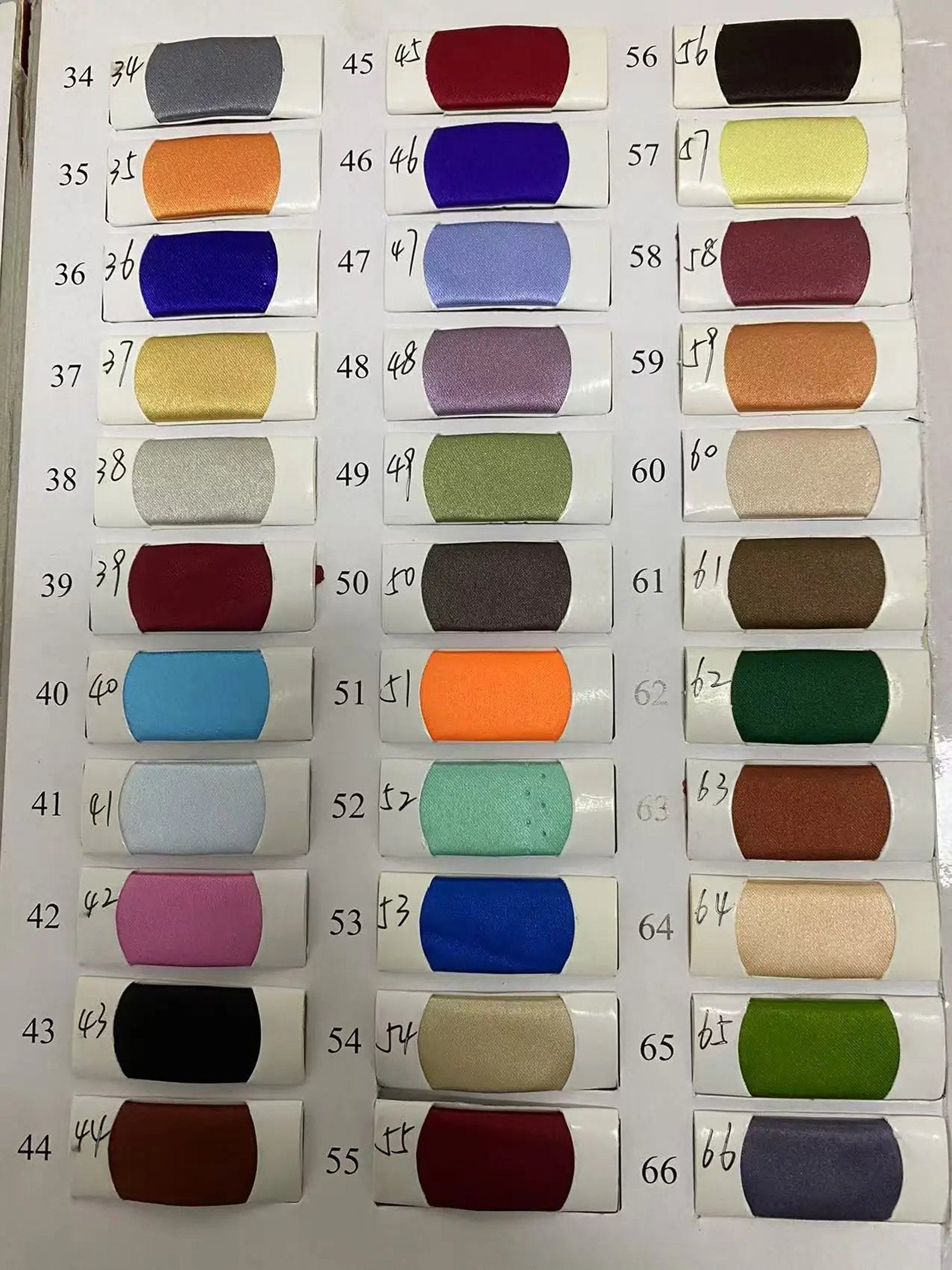 Color swatches for off shoulder mermaid evening dress by LuckeLadybug LLC showcasing various fabric options