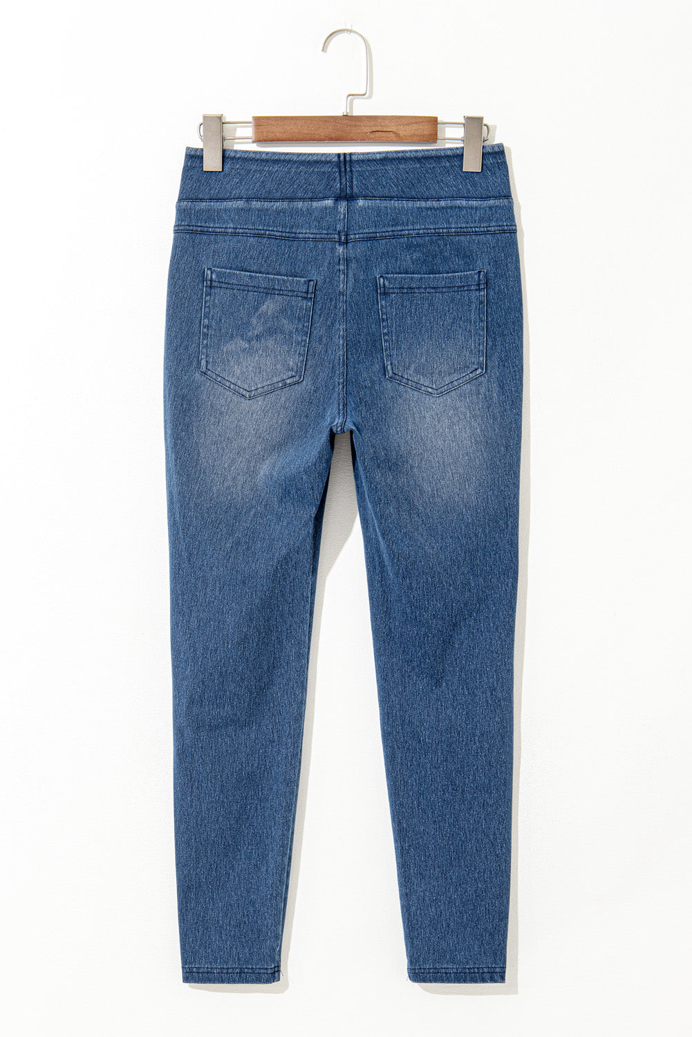 Back view of Old Navy jeggings featuring a fitted design and classic blue wash finish