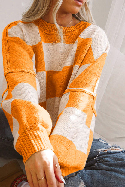 Orange checkered bishop sleeve sweater featuring a cozy relaxed fit and soft texture