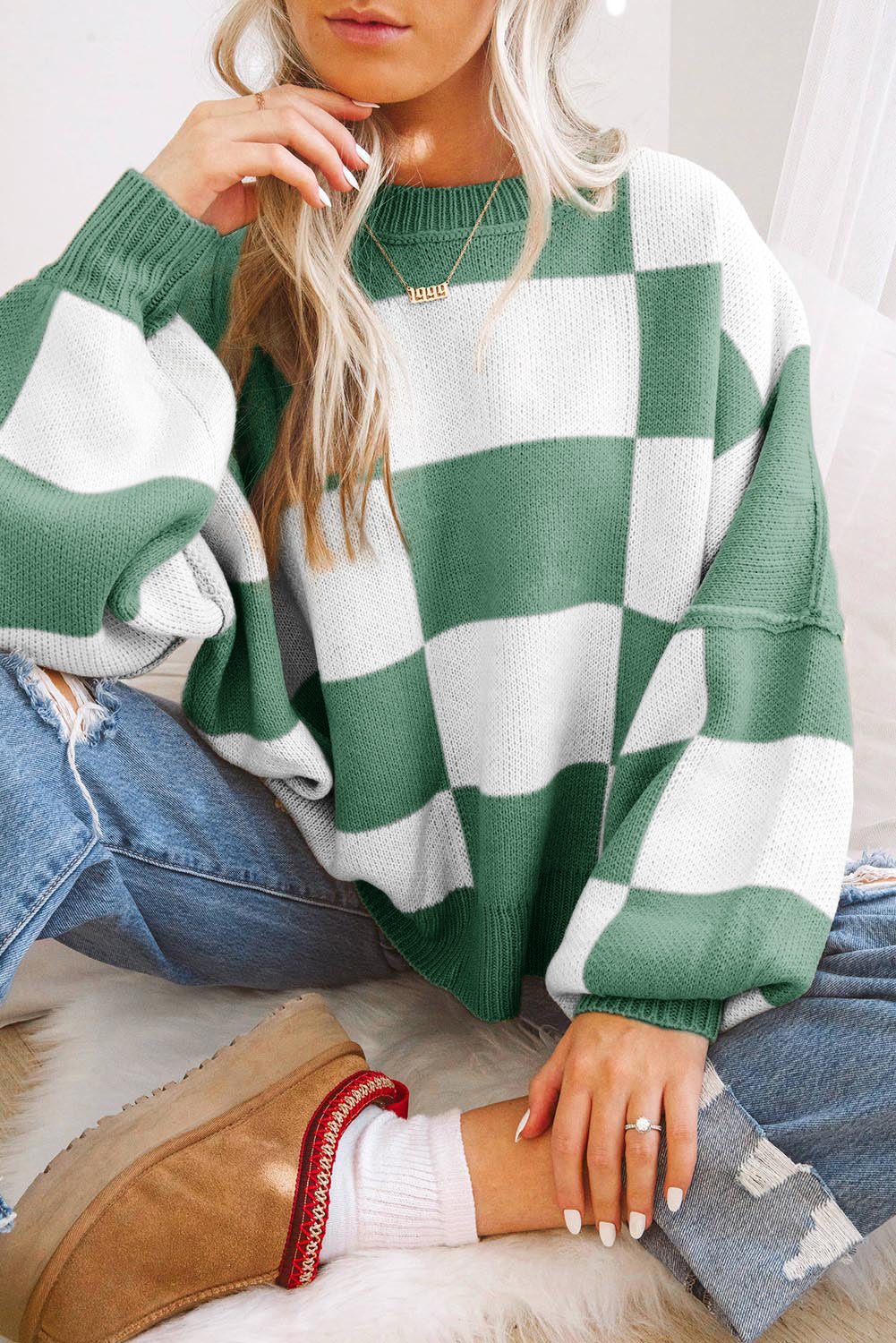Green and white oversized sweater with bishop sleeves, not the orange checkered bishop sleeve sweater