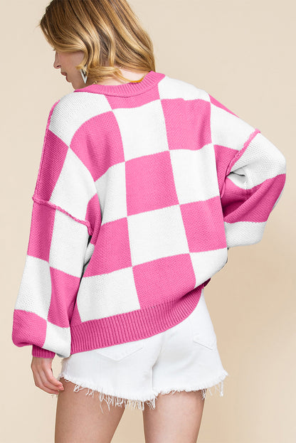 LuckeLadybug orange checkered bishop sleeve sweater in a vibrant pink and white pattern