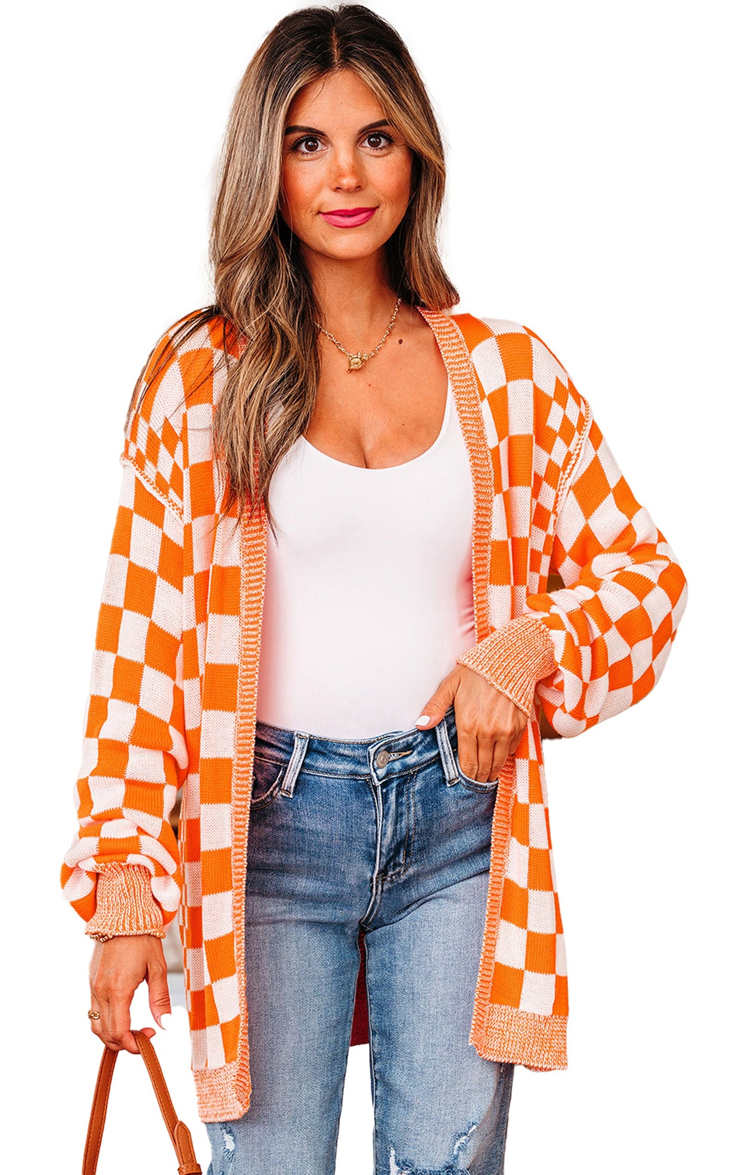 Stylish orange checkered cardigan worn over a white top, paired with jeans for a trendy look