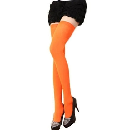 Orange thigh-high stockings worn with a skirt and heels, perfect complement to stylish outfits