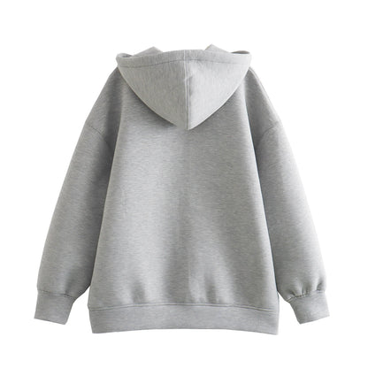 Back view of a gray oversized zip up hoodie for women with a cozy hood and wide sleeves