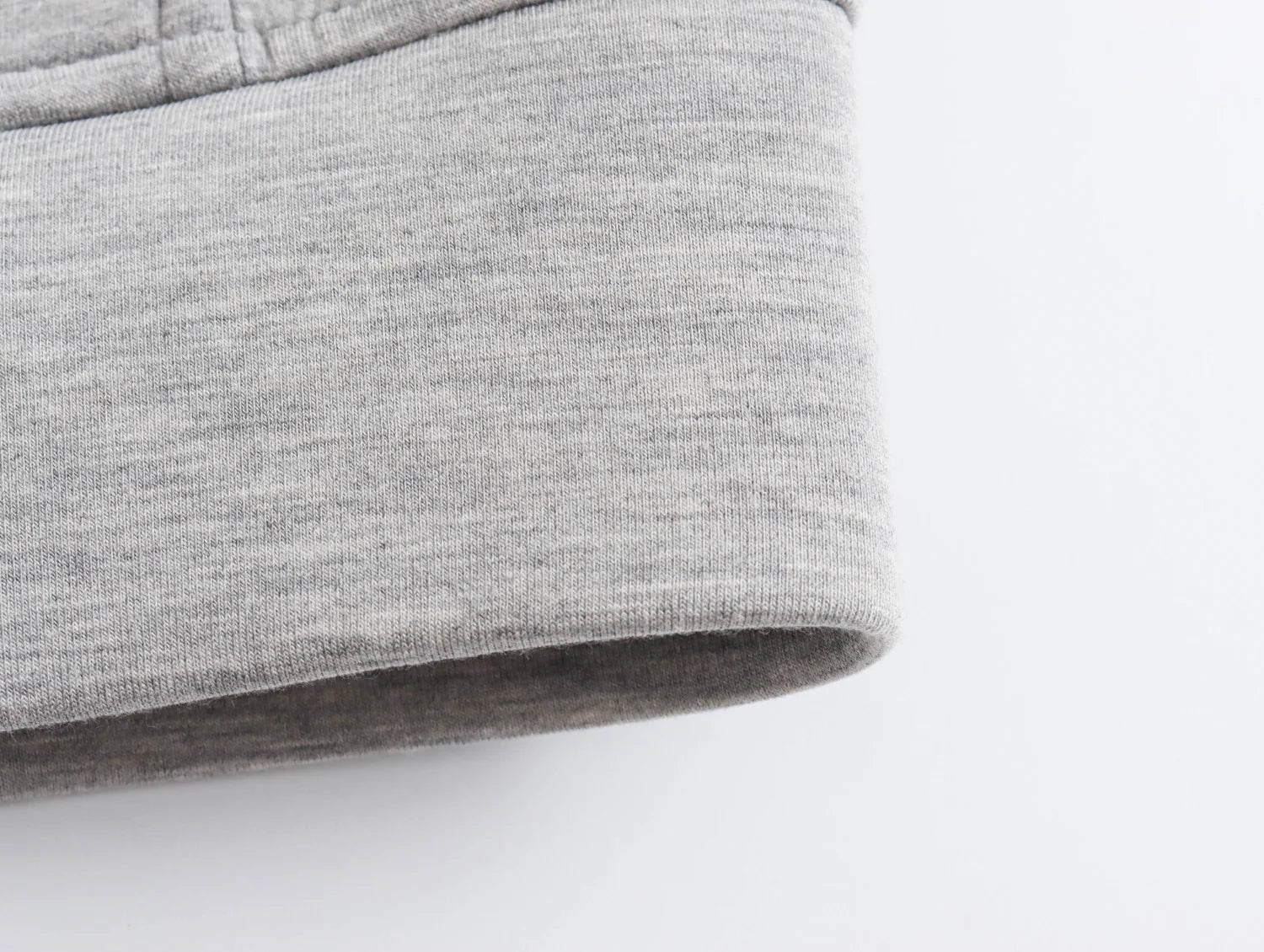 Close-up view of gray fabric showcasing the cuff of an oversized zip up hoodie for women