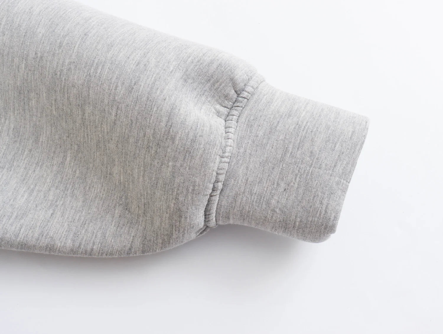 Detail of a light gray oversized zip up hoodie for women showcasing the cuff design
