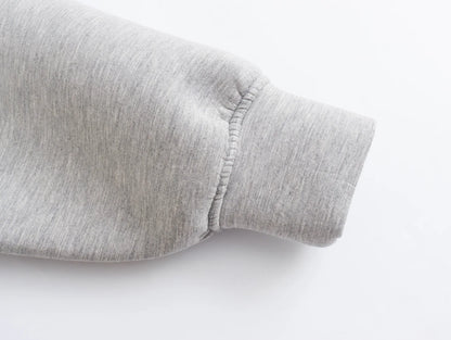 Detail of a light gray oversized zip up hoodie for women showcasing the cuff design