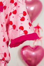 Pink LuckeLadybug LLC pajama set featuring heart and bow patterns with ruffled sleeves