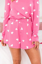Pink shorts with heart to print design, featuring a comfortable elastic waistband and button closure