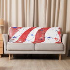 LuckeLadybug Sherpa Blanket patriotic bedding throw with red white and blue stars and stripes draped on beige sofa