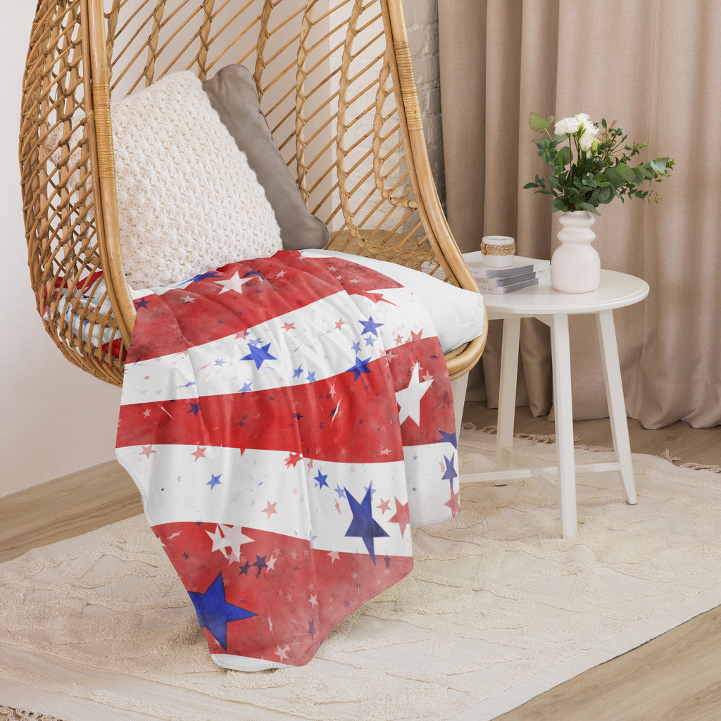 LuckeLadybug sherpa blanket patriotic bedding throw with red white and blue star design draped over wicker hanging chair