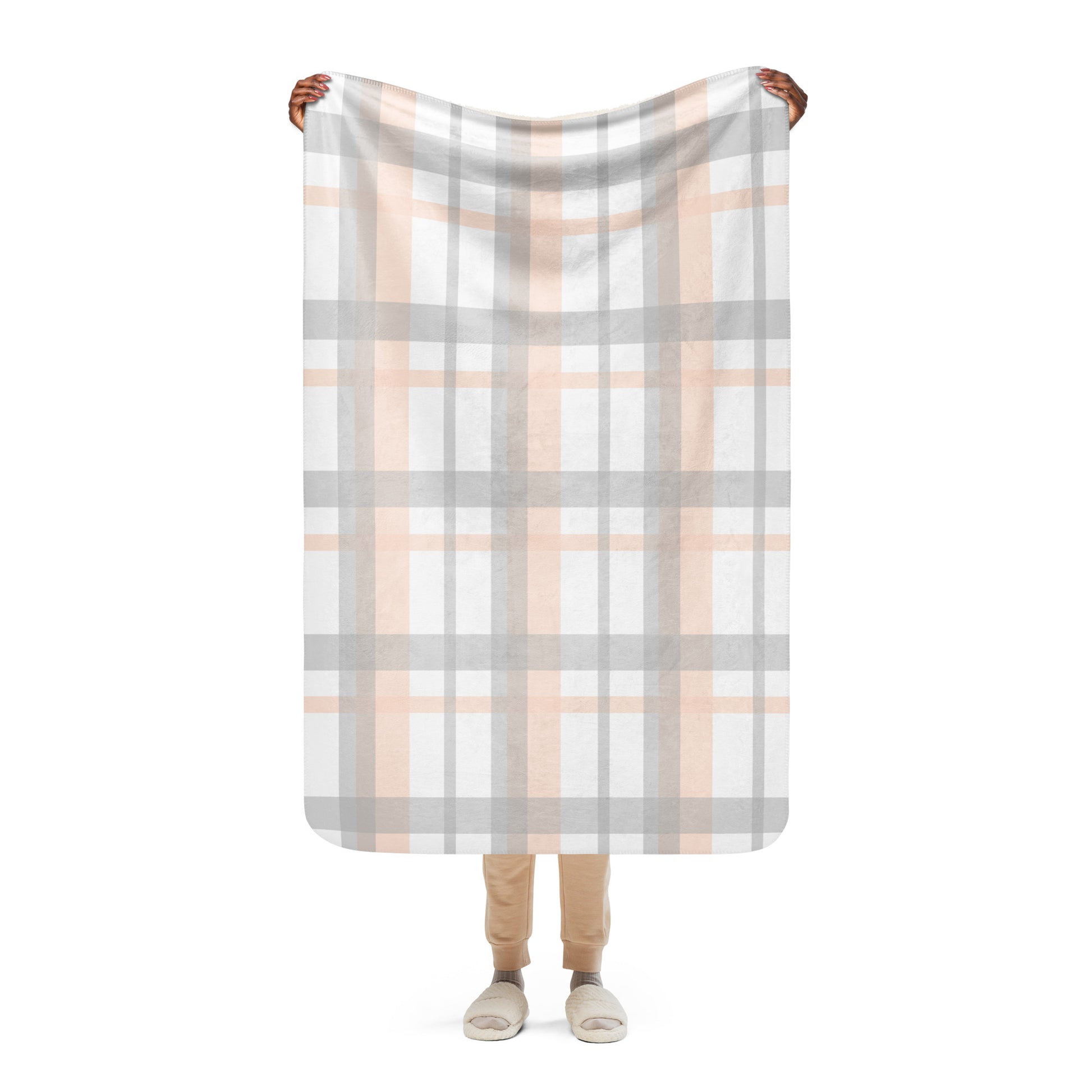 LuckeLadybug peach grey plaid sherpa blanket held up by person showing full pattern and soft texture