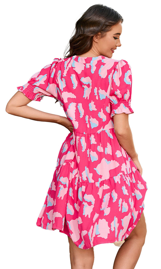 Pink abstract puff sleeve dress featuring a flared skirt and back tie detail, perfect for a stylish look