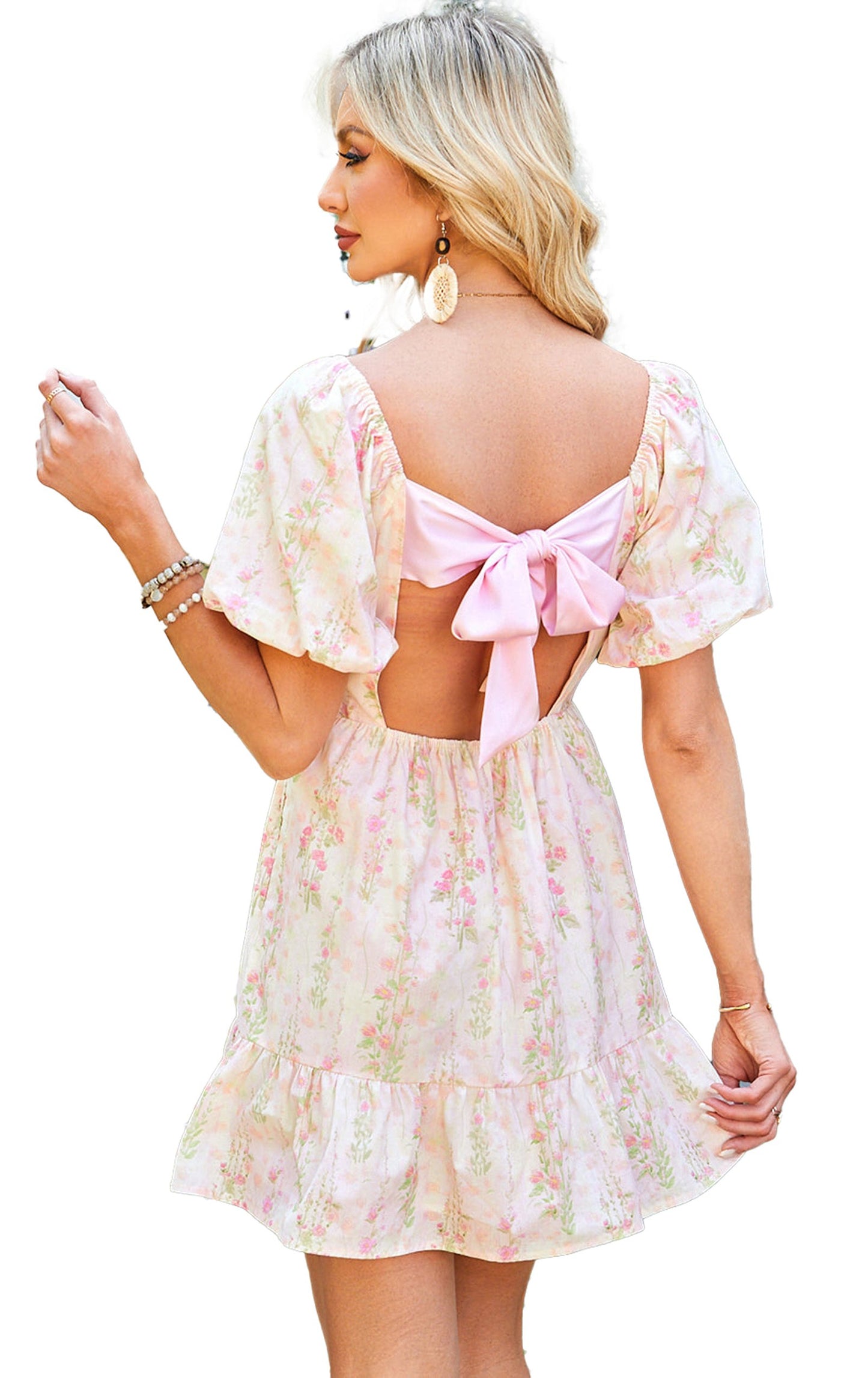 LuckeLadybug pink floral mini dress with back bow detail and flutter sleeves in a garden setting